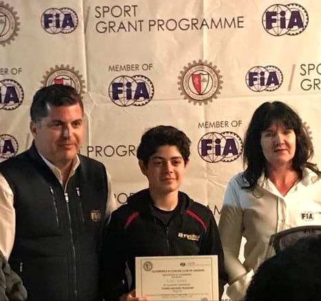 Karl Saad receiving an FIA related certificate and recognition