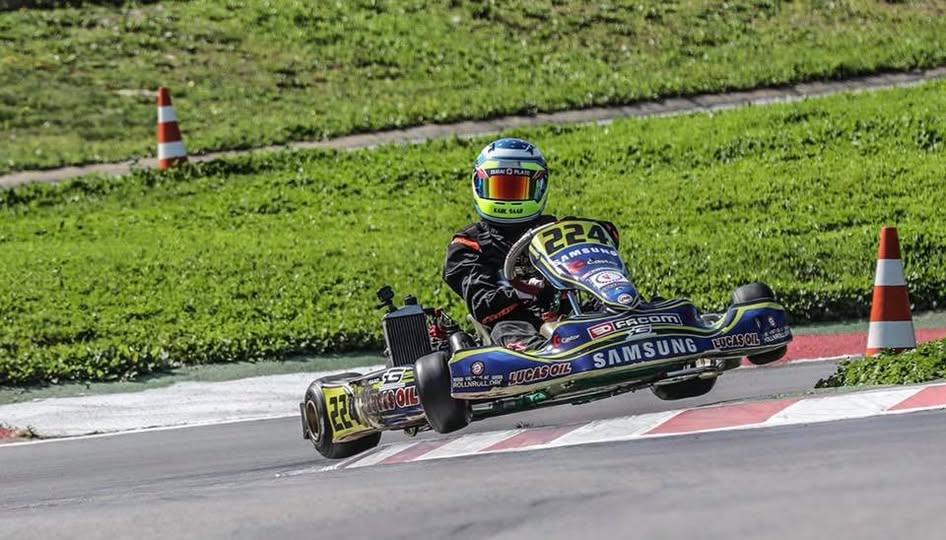 Karl Saad lifting a wheel over a curb during a kart race